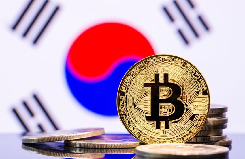 An image showing a representation of a bitcoin token against the backdrop of a South Korean flag.