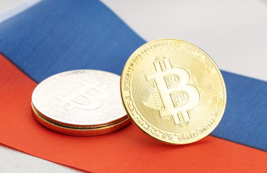 Tokens representing Bitcoin rest on the Russian national flag.