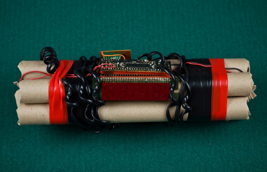 A home-made bomb, featuring sticks of dynamite, a digital timer, wires, and duct tape.