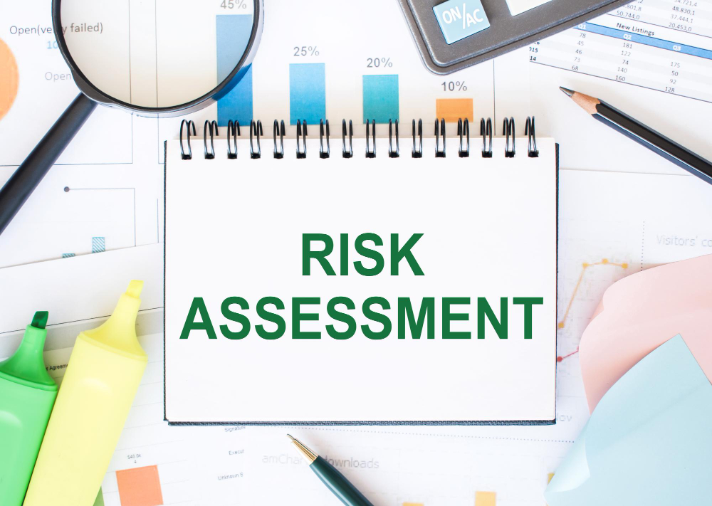 A notebook with the word risk assessment on it.