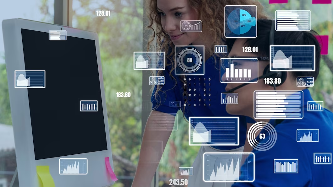 A woman is looking at a computer screen with a lot of icons on it.