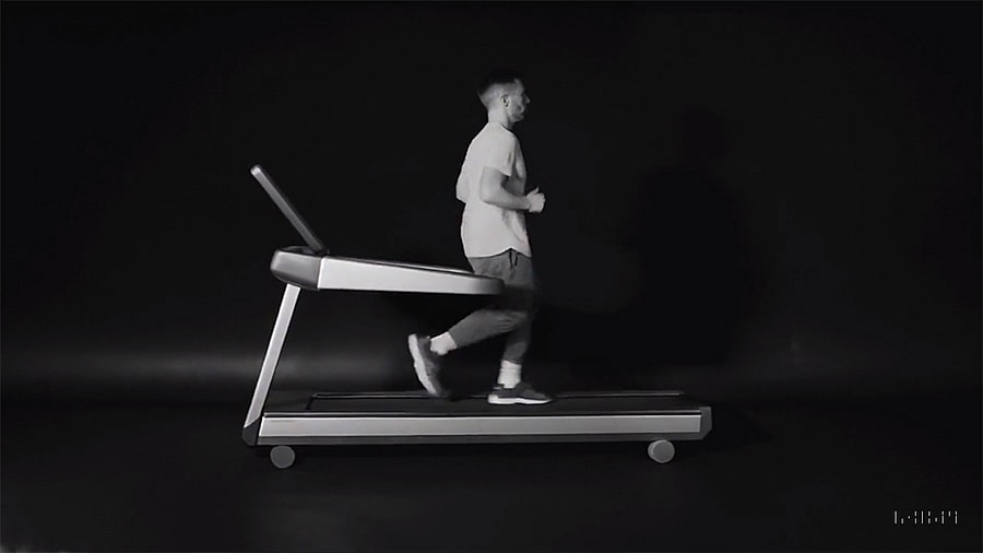 Sora AI generating a video of a man running in reverse on a treadmill.